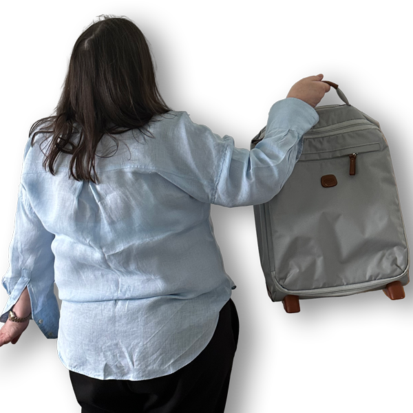 Picture of the back of Fiona holding a suitcase