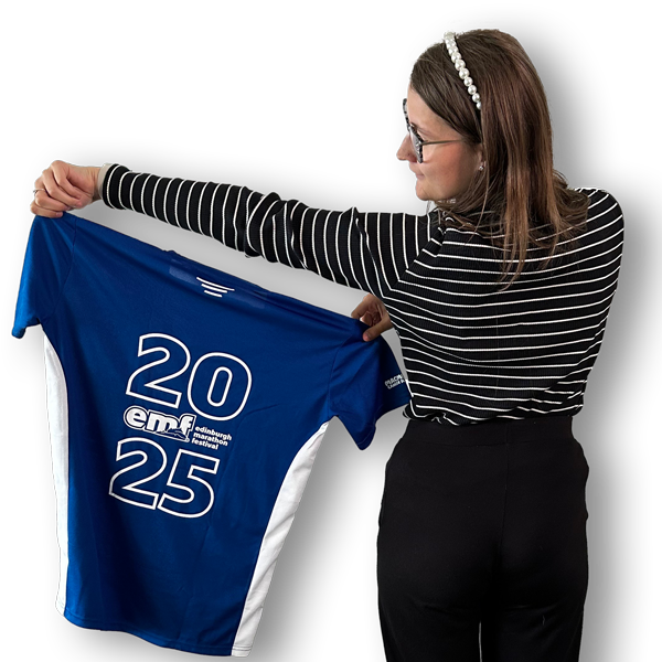 Picture of the back of Holly holding a marathon finisher t-shirt