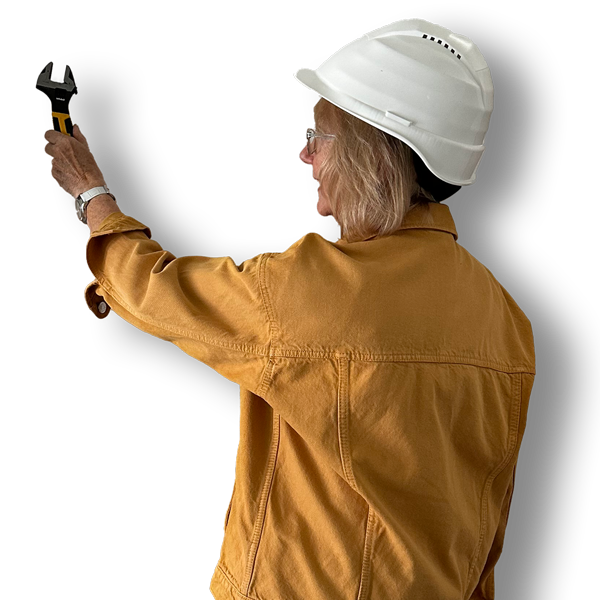 Picture of the back of Kathy holding a spanner and wearing a helmet