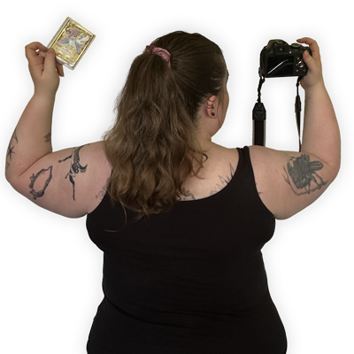 Picture of the back of Freya holding a Pokemon Card and a camera
