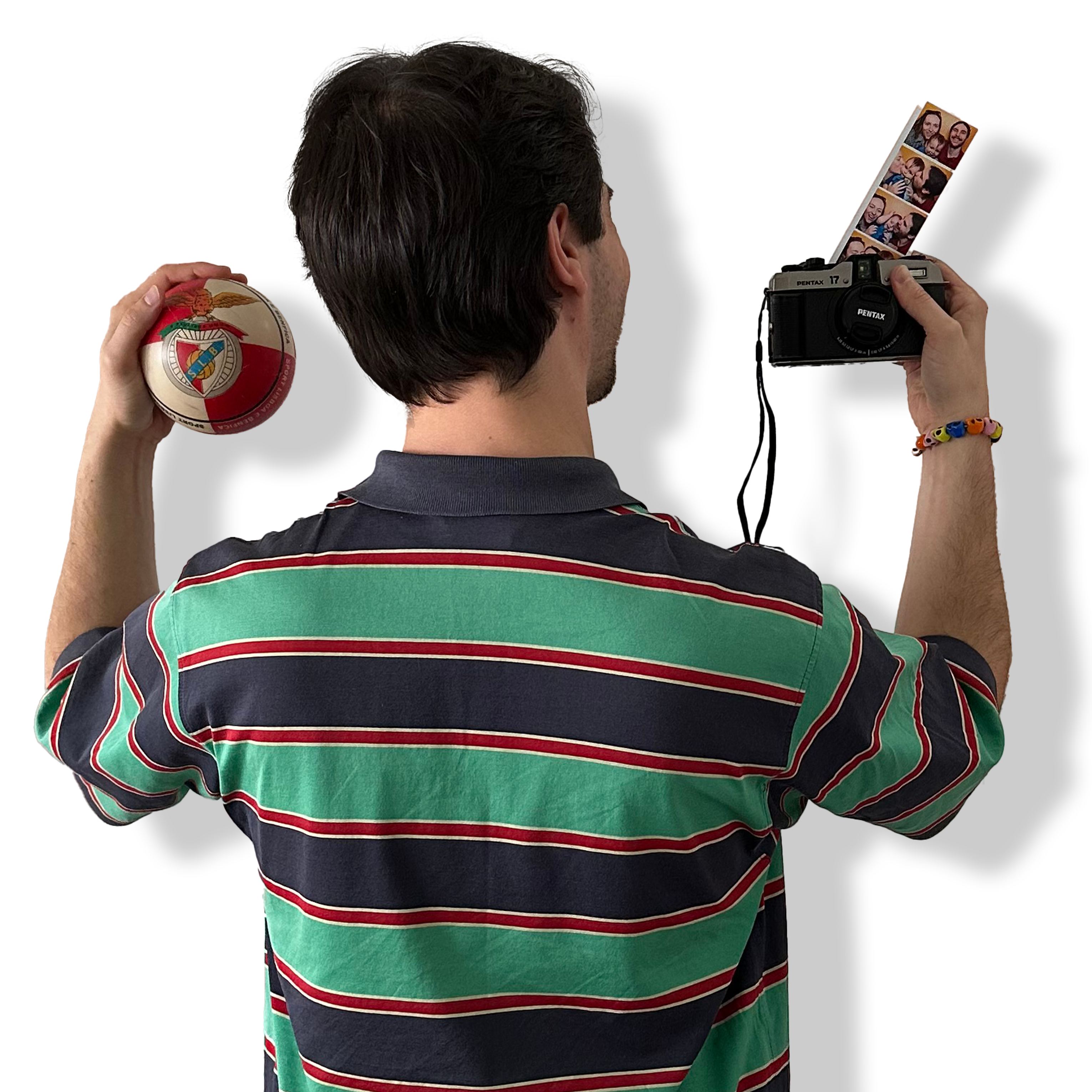 Picture of the back of Luis holding a camera and a football