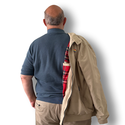 Picture of the back of Paul wearing a tartan jacket and an LGBTQ+ Badge